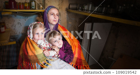Mother with kids in cellar 109019542