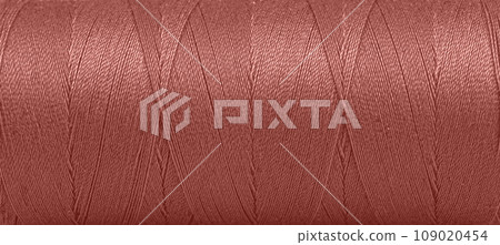 Texture of threads in a spool of brown color on a white background Texture of threads in a spool of brown color on a white background 109020454