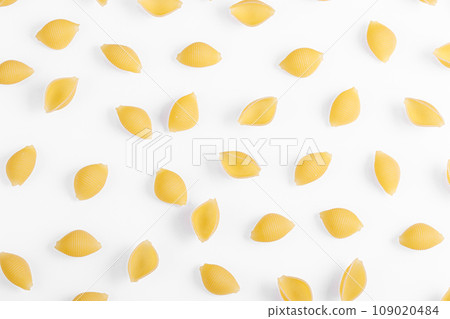 Pasta products in the form of a shell, texture, on a white background Pasta products in the form of a shell, texture, on a white background 109020484