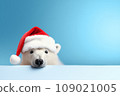 White polar bear in Santa Claus hat isolated on light blue background. New Year or Christmas concept. Banner with a white polar bear and copy space. 109021005