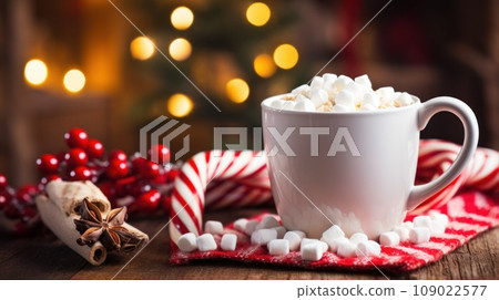 a cup of hot cocoa with marshmallows and a candy cane, a cup of hot cocoa with marshmallows and a candy cane, 109022577