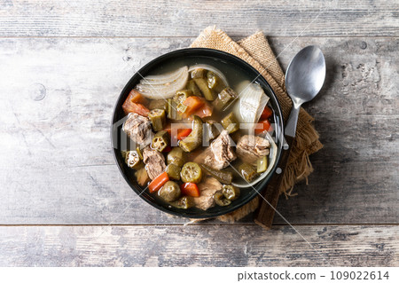 Traditional African okra soup on wooden table Traditional African okra soup on wooden table 109022614