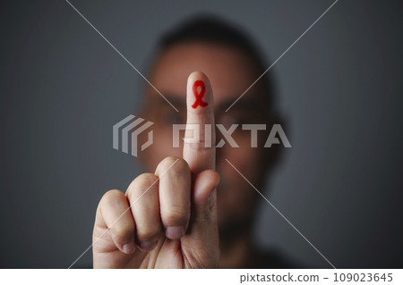 man with red ribbon for the fight against AIDS 109023645