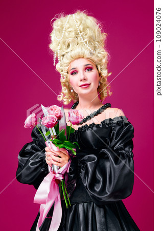 Hidden revenge. Portrait of queen young lady holding bunch of flowers with sharp knives against magenta background. Hidden revenge. Portrait of queen young lady holding bunch of flowers with sharp knives against magenta background. 109024076