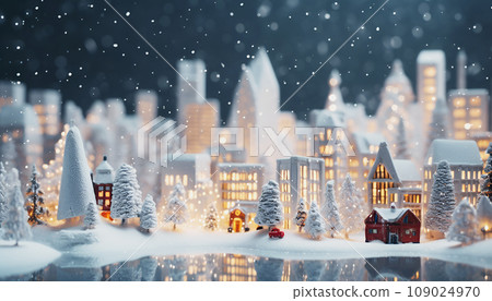 Christmas miniature town, small village illuminated model. Scene of cozy festive snowy houses, toy buildings, lights, night bokeh, cute lantern decorations, trees covered with white snow. New Year 109024970