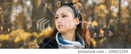 Banner Outdoor atmospheric lifestyle portrait of young beautiful young woman copy space. Warm autumn fall season. Millennial generation and youth 109025204