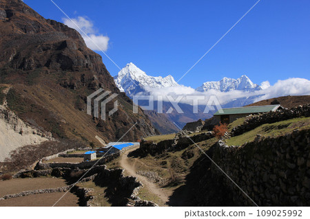 Snow covered mountains Thamserku, Kantega and Kusum Kangaru seen from a place near Thame, Nepal. 109025992