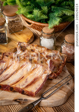 Smoked pork bone on wooden board. 109026014