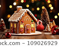 Gingerbread house on table. Defocused lights of Christmas garland. Evening in the living room. Holiday mood.  109026929