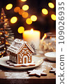 Gingerbread house on table. Defocused lights of Christmas garland. Evening in the living room. Holiday mood.  109026935