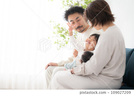 A family admiring a newborn baby 109027209