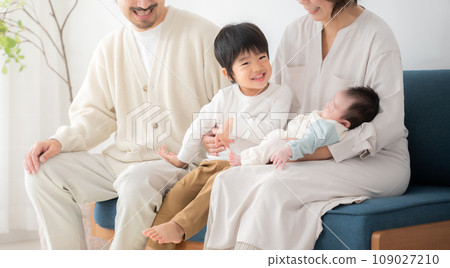 A family admiring a newborn baby 109027210