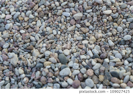 Beach pebbles on the sea background. Gray river stones 109027425