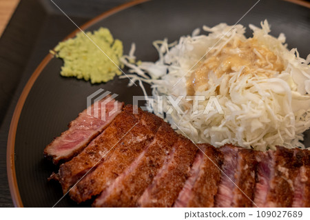 Gyukatsu or beef cutlet. A traditional Japanese food that consists of a deep-fried beef cutlet. served with vegetable 109027689