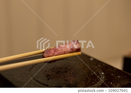 Gyukatsu or beef cutlet. A traditional Japanese food that consists of a deep-fried beef cutlet. on the stone grill Gyukatsu or beef cutlet. A traditional Japanese food that consists of a deep-fried beef cutlet. on the stone grill 109027691