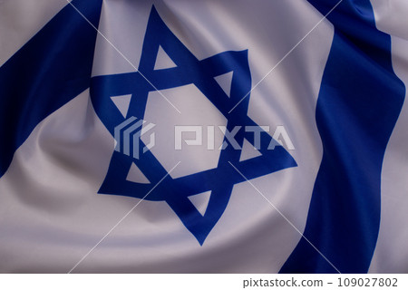 Banner with Official flag of Israel on a white background and copy space. Israeli flag for Jewish Holidays and independence day. Banner with Official flag of Israel on a white background and copy space. Israeli flag for Jewish Holidays and independence day. 109027802