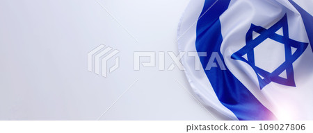 Banner with Official flag of Israel on a white background and copy space. Israeli flag for Jewish Holidays and independence day. Banner with Official flag of Israel on a white background and copy space. Israeli flag for Jewish Holidays and independence day. 109027806