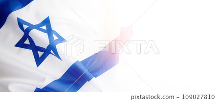 Banner with Official flag of Israel on a white background and copy space. Israeli flag for Jewish Holidays and independence day. Banner with Official flag of Israel on a white background and copy space. Israeli flag for Jewish Holidays and independence day. 109027810