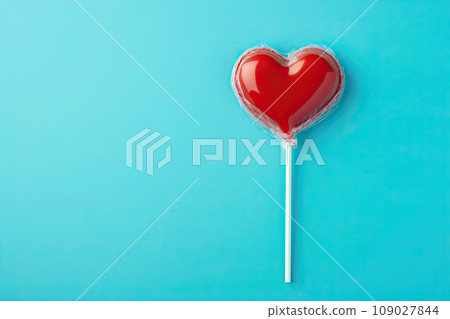 Heart shaped candy lollipop for valentines day on blue background Heart shaped candy lollipop for valentines day on blue background 109027844
