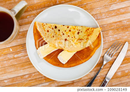 Crepes served in a plate with brie cheese 109028149