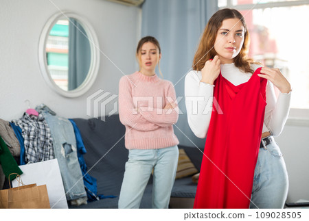 Two young women choosing clothes to wear 109028505