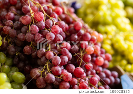 Bunch of grapes lies on counter in shop Bunch of grapes lies on counter in shop 109028525