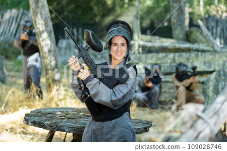 Portrait of happy woman in paintball equipment 109028746