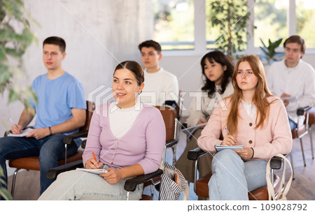 Group of high school students listening to lecture in auditorium 109028792