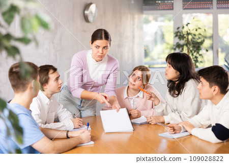 Young female student taking part in group discussion with coursemates 109028822