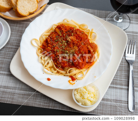 Dinner on table - delicious spaghetti with sausage and sauce Dinner on table - delicious spaghetti with sausage and sauce 109028998