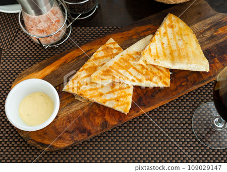 Traditional Mexican Quesadillas with cheese and sauce Traditional Mexican Quesadillas with cheese and sauce 109029147