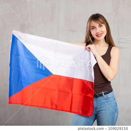 Young happy pretty woman displaying flag of czech republic 109029158