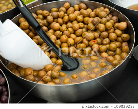 Heap of green olives with pits in buckets Heap of green olives with pits in buckets 109029252