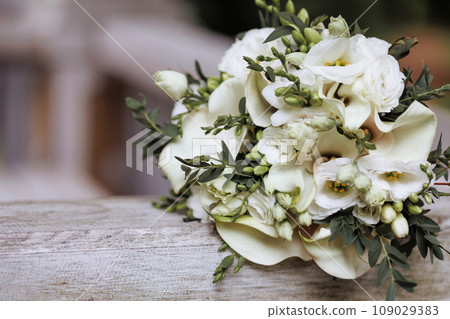 White rose bouquet with greenery on wood White rose bouquet with greenery on wood 109029383