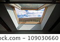 View from the open window at attic on blue sky with clouds 109030660