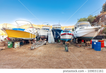 Repaired fishing boats on carts on the shore of the bay in the village of Symi. 109031161