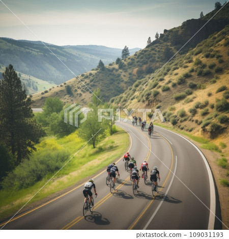 cyclists riding through a winding mountain road, with a beautiful scenic landscape 109031193