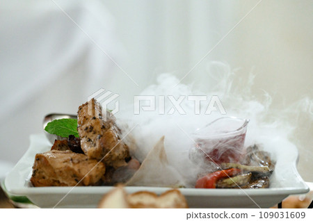 A hot dish with pieces of steaming meat. A hot dish with pieces of steaming meat. 109031609