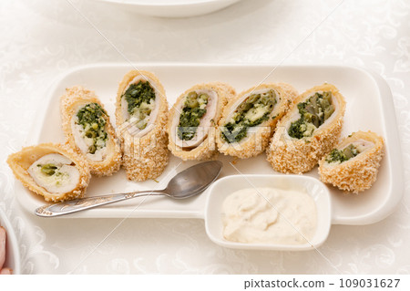 Chicken roll fried in breading on a white plate. Chicken roll fried in breading on a white plate. 109031627