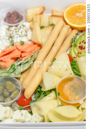 Sliced cheese on a plate with honey and sweet sauce. 109031633