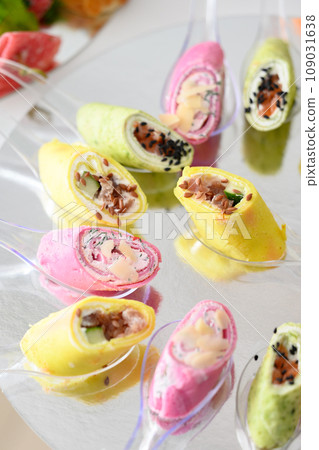 Cheese snack in rolls on small disposable spoons Cheese snack in rolls on small disposable spoons 109031638