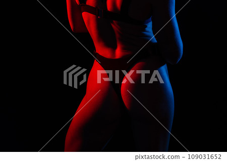 Seductive young beautiful ass in thong black underwear, dark background. Seductive young beautiful ass in thong black underwear, dark background. 109031652