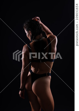Seductive young beautiful ass in thong black underwear, dark background. 109031654