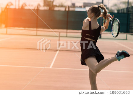 Sexy girl tennis player holding tennis racket on the court. Young woman is playing tennis. 109031663