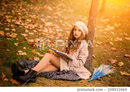 Young attractive smiling girl under umbrella in autumn forest Young attractive smiling girl under umbrella in autumn forest 109031664