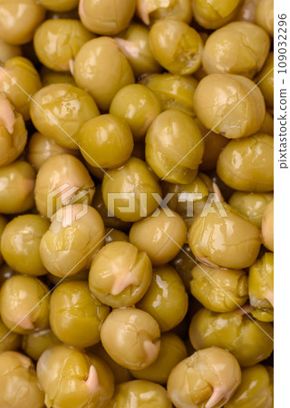 Delicious canned green peas with salt and spices in a white bowl Delicious canned green peas with salt and spices in a white bowl 109032296