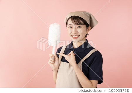 一位女房清潔工人，帶著粉紅色背景的方便拖把 109035758