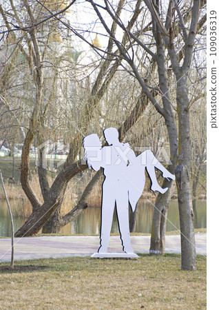 iron figure of a loving couple. man holding woman in his arms iron figure of a loving couple. man holding woman in his arms 109036319