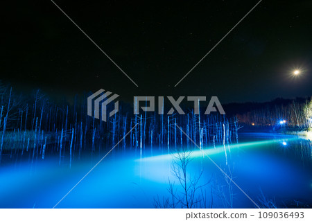 Illuminated night view of Aoi Pond, a tourist attraction with sparkling blue water | Shirokane, Biei-cho, Hokkaido | November 109036493