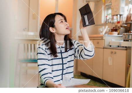 A depressed young woman checking inside her wallet A depressed young woman checking inside her wallet 109036618